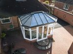 conservatory extension with a black roof lantern and uPVC french doors