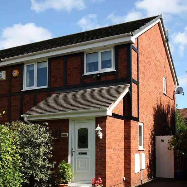 red brick house with white casement windows