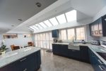 large roof lantern and upvc white windows in a modern kitchen