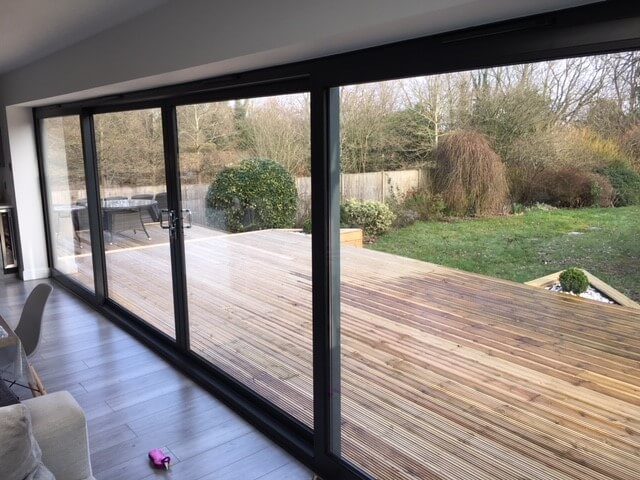 closed aluminium sliding door with a wooden deck outside