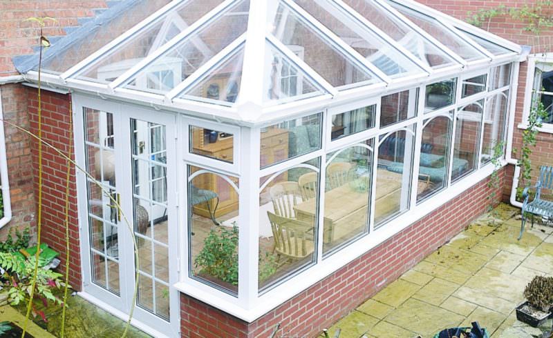 Edwardian conservatory with a glass roof and Georgian bar French doors