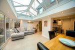 inside of a furnished extension with bifolding doors and lantern roof