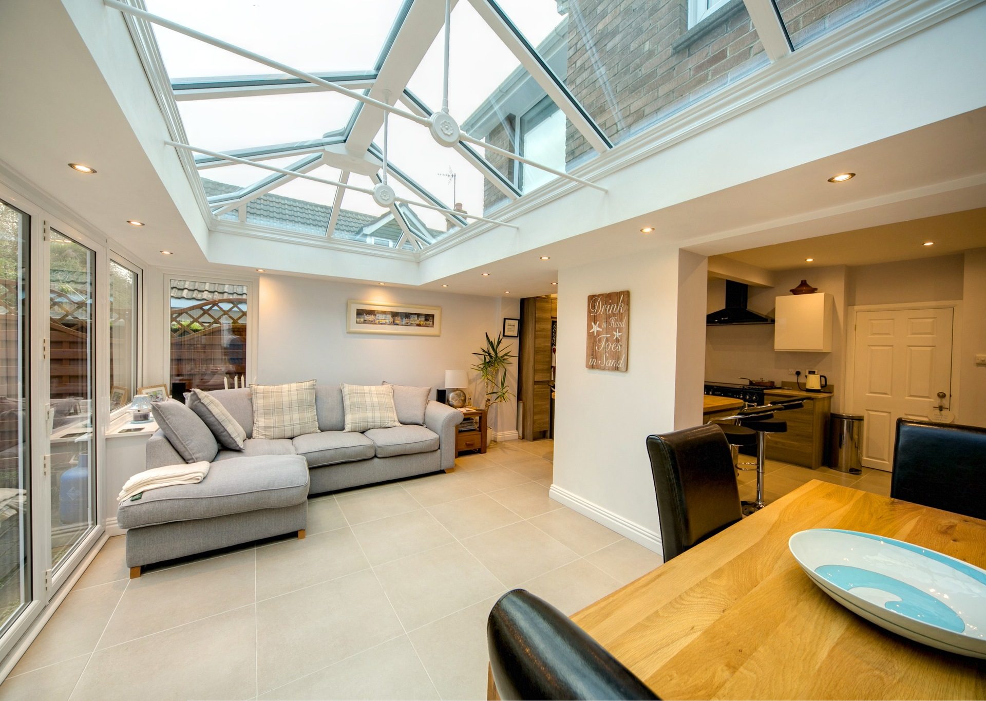 inside of a furnished extension with bifolding doors and lantern roof