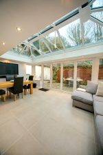 inside an extension with bifold doors and a white lantern roof