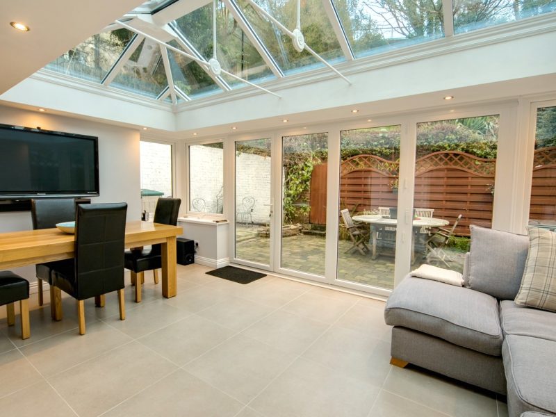 inside an extension with bifold doors and a white lantern roof