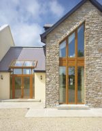 Light brown French doors and windows on a cobblestone home