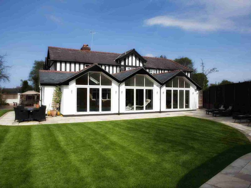 Victorian style home with three extensions with a large front lawn