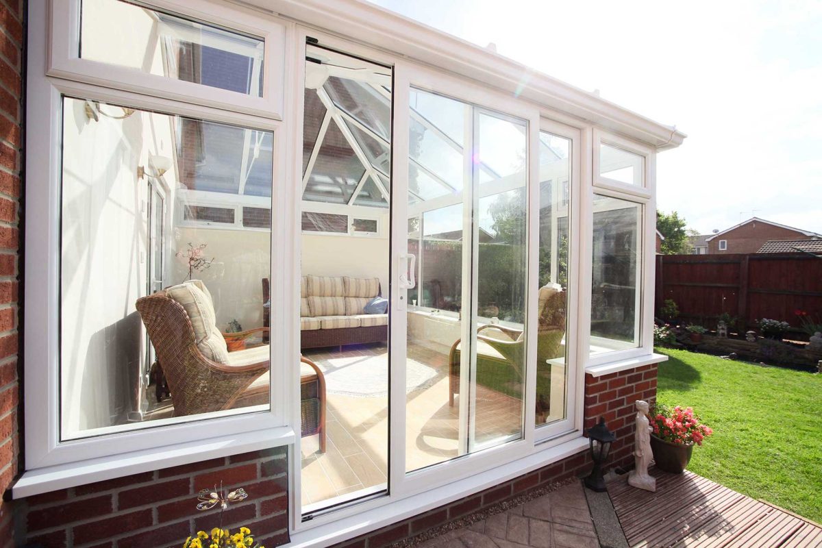 white uPVC Conservatory with liniar patio door