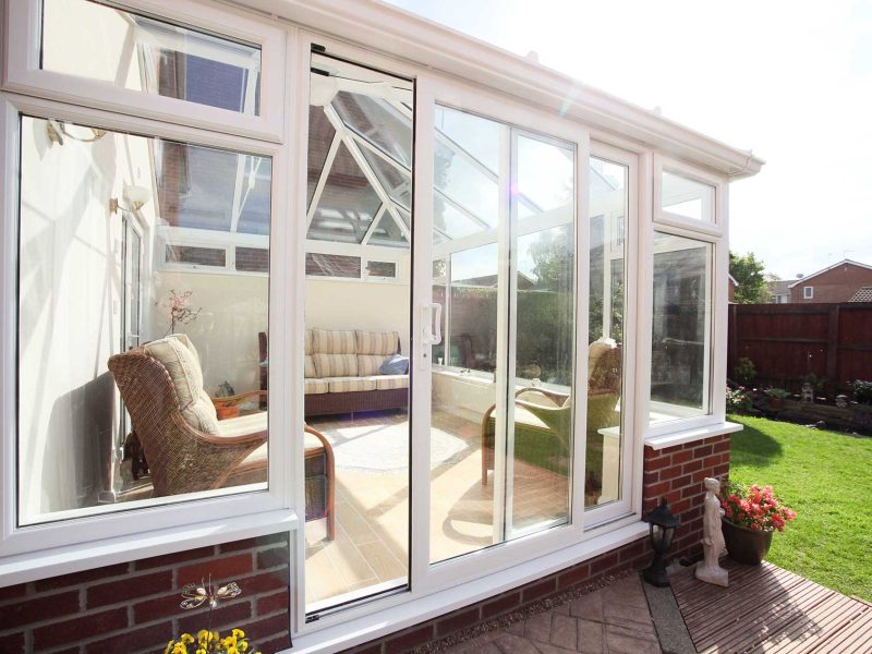 white uPVC Conservatory with liniar patio door