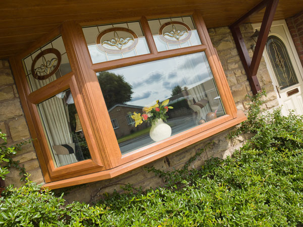 brown woodgrain bay window with decorative glazing