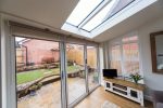 white room with casement windows a roof lantern and double glazed doors