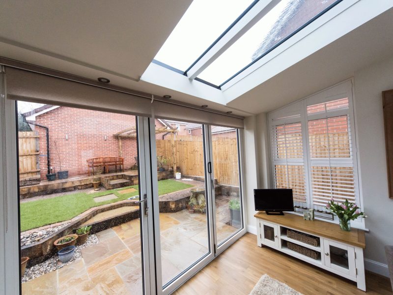 white room with casement windows a roof lantern and double glazed doors