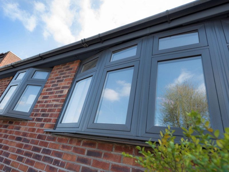 dark grey uPVC flush casement windows in a bay window format