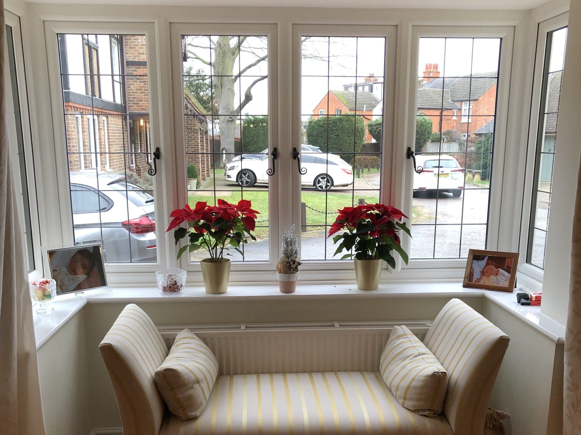 triple glazed white upvc bay window with a cream sofa in front