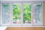 white upvc windows with triple glazing leading to a green tree outside