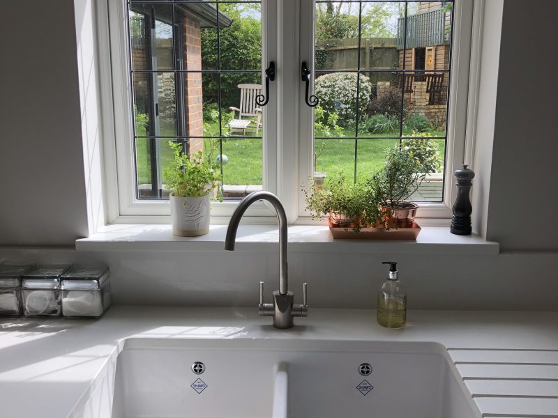 Highly secure white triple glazed Leaded uPVC windows above a kitchen sink